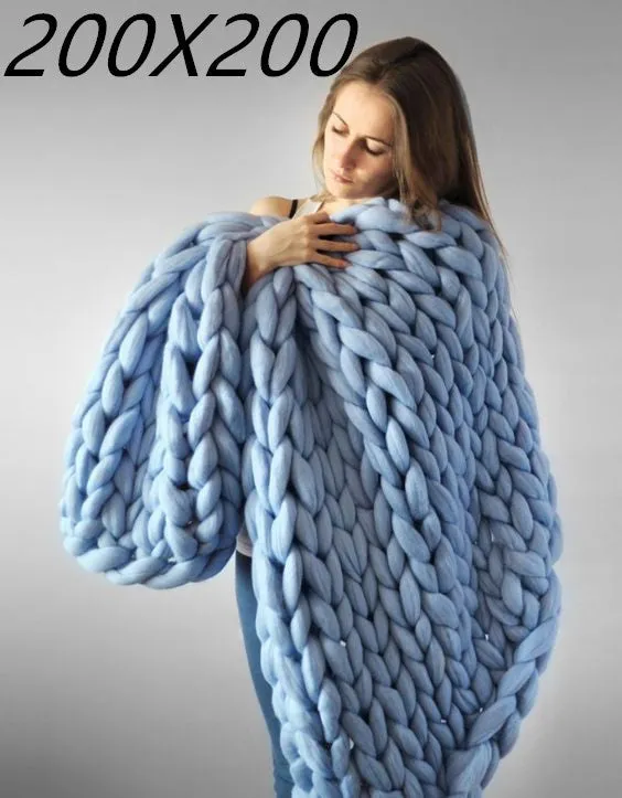 Hand woven chenille blanket in dark grey colour draped over a sofa, available in multiple sizes