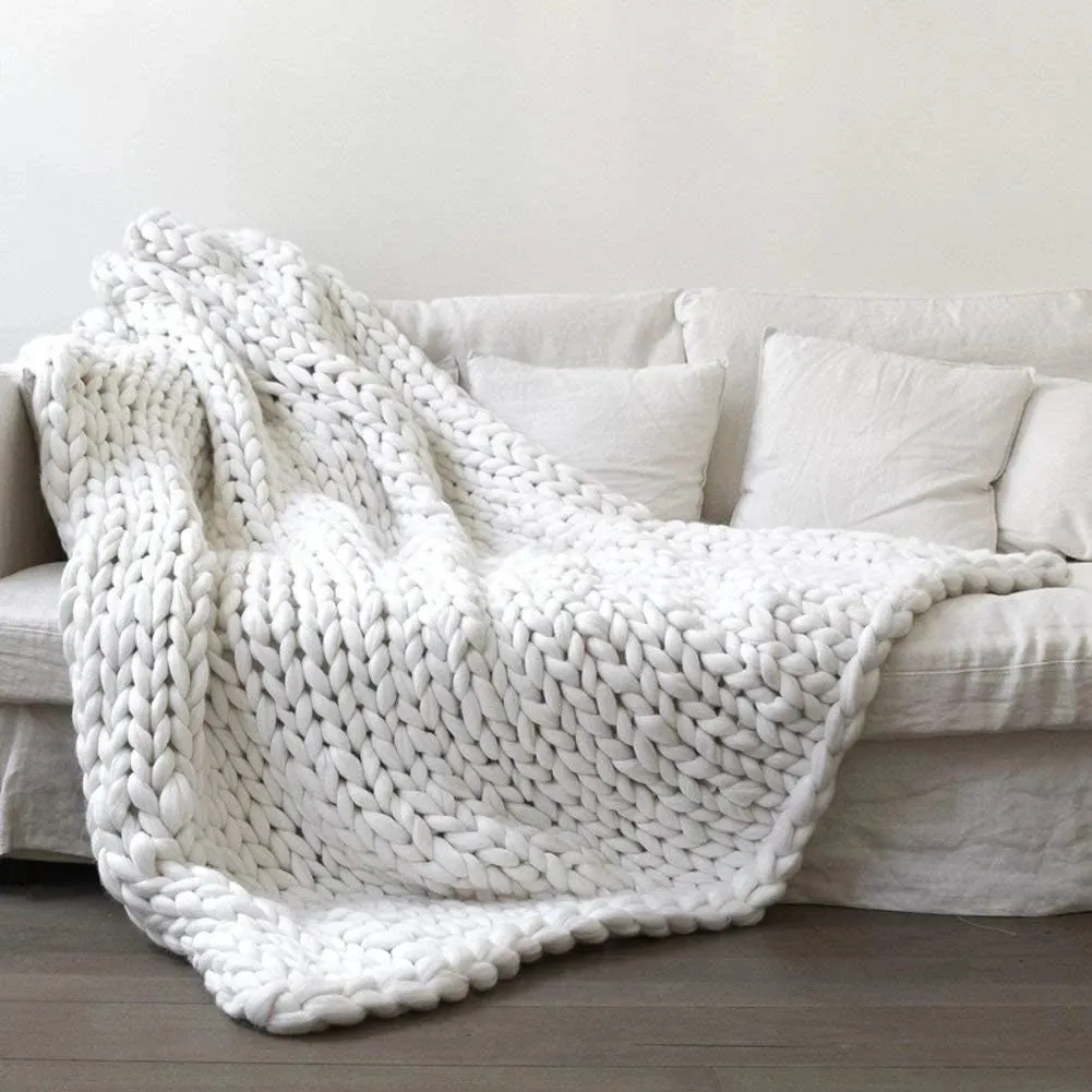 Hand woven chenille blanket in dark grey colour draped over a sofa, available in multiple sizes