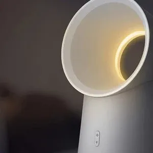 White desktop bladeless fan with USB power and humidification spray on a desk