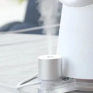 White desktop bladeless fan with USB power and humidification spray on a desk