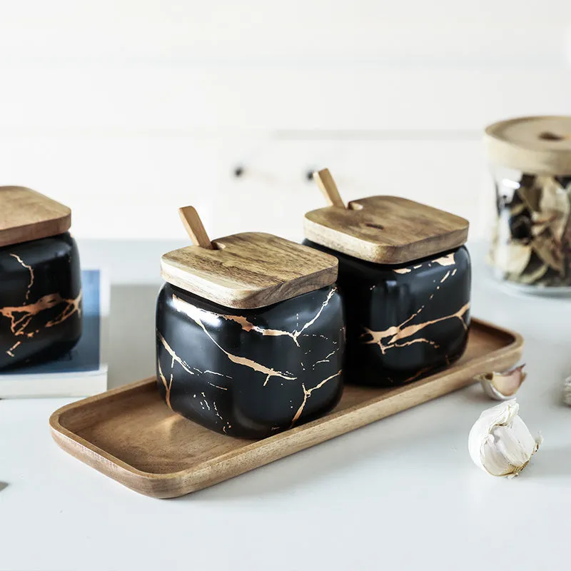 Nordic gold marble ceramic jar set with wooden tray and bamboo spoon on a kitchen counter