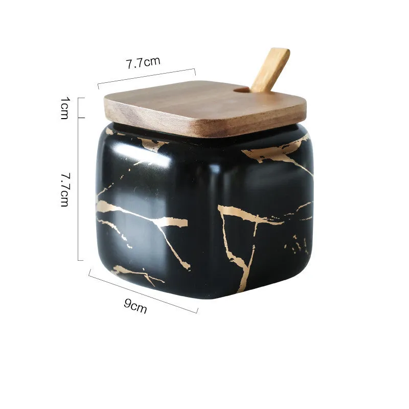 Nordic gold marble ceramic jar set with wooden tray and bamboo spoon on a kitchen counter