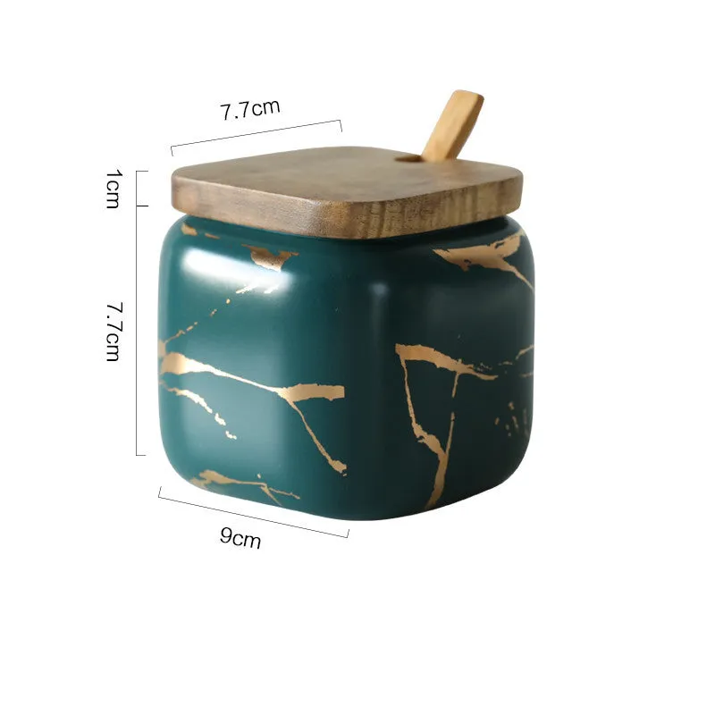 Nordic gold marble ceramic jar set with wooden tray and bamboo spoon on a kitchen counter