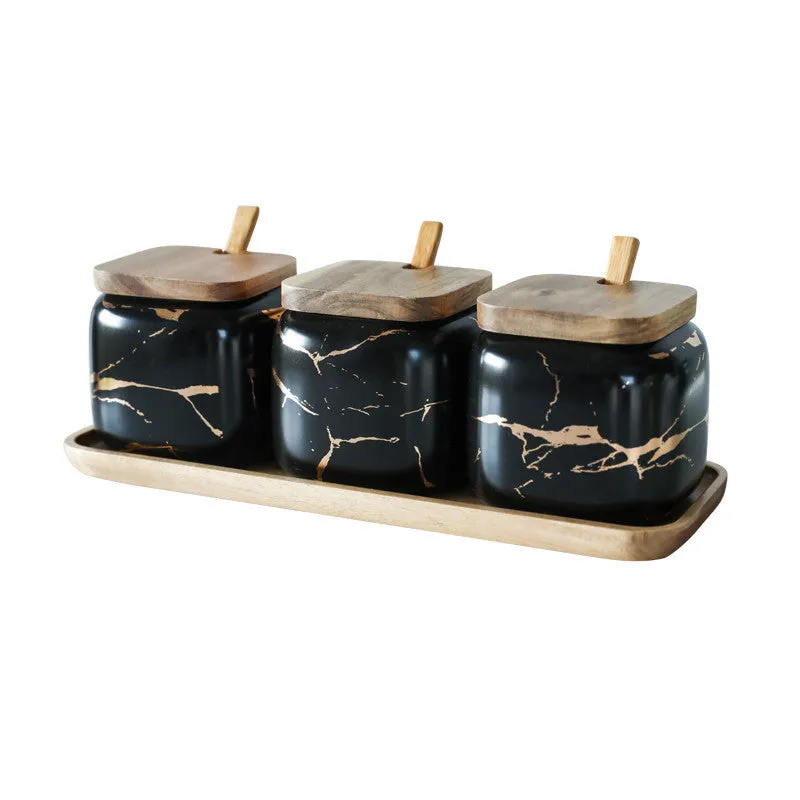 Nordic gold marble ceramic jar set with wooden tray and bamboo spoon on a kitchen counter