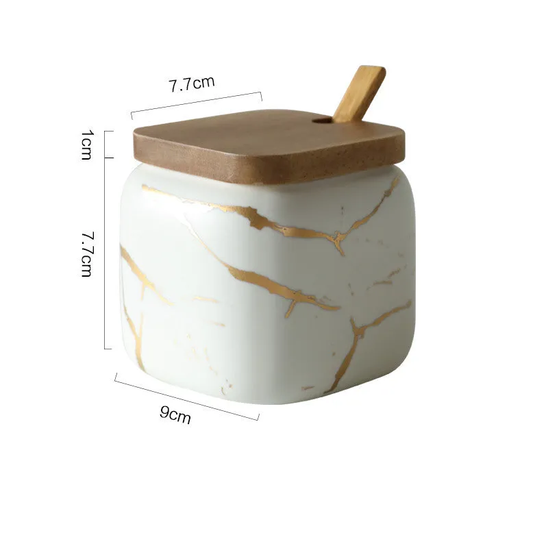 Nordic gold marble ceramic jar set with wooden tray and bamboo spoon on a kitchen counter