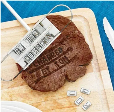 Silver aluminium alloy BBQ branding iron with 55 letters and 8 spaces for personalised meat stamping on a wooden surface