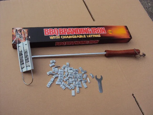 Silver aluminium alloy BBQ branding iron with 55 letters and 8 spaces for personalised meat stamping on a wooden surface