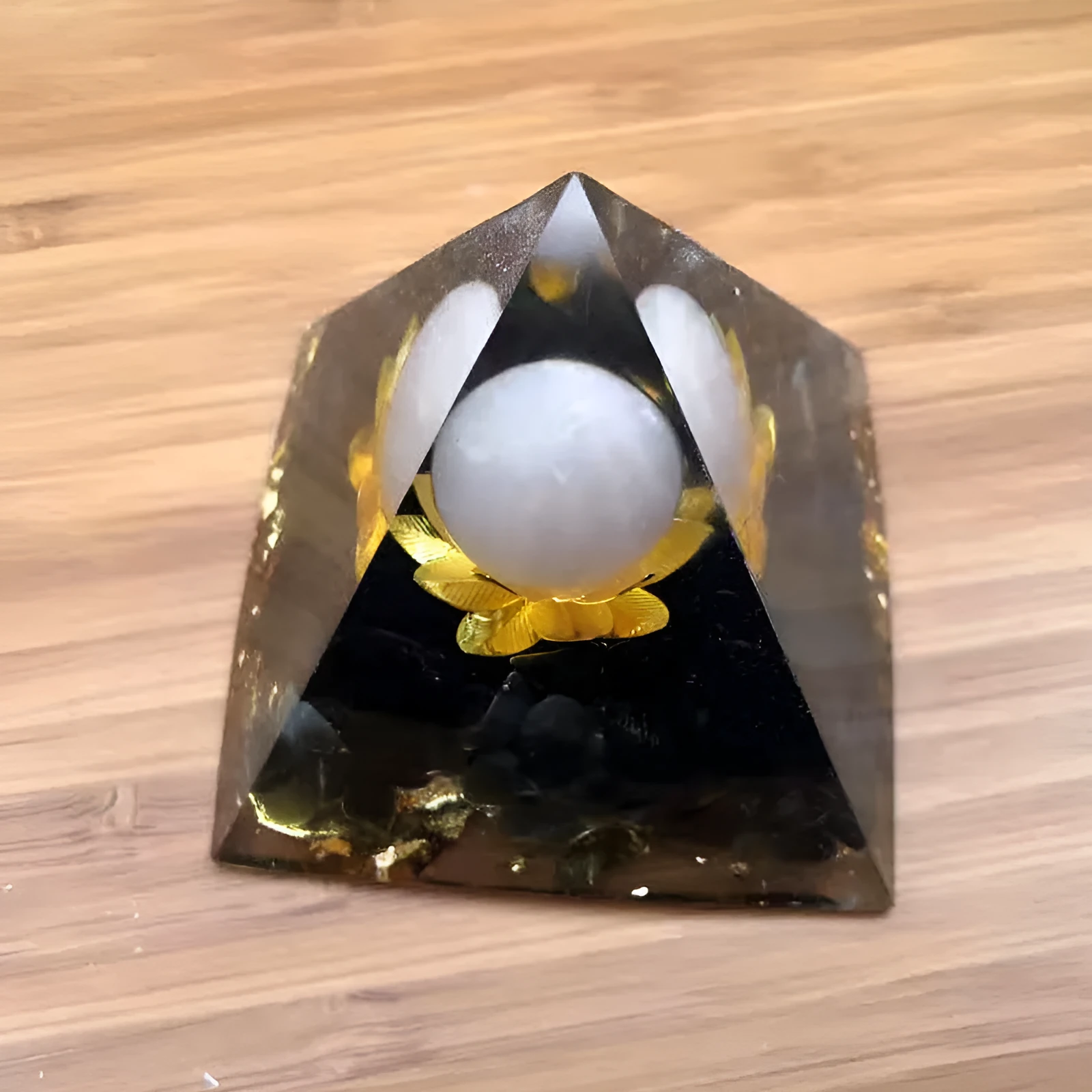 Black resin pyramid ornament 60x60mm on a white surface with white square paper box packaging