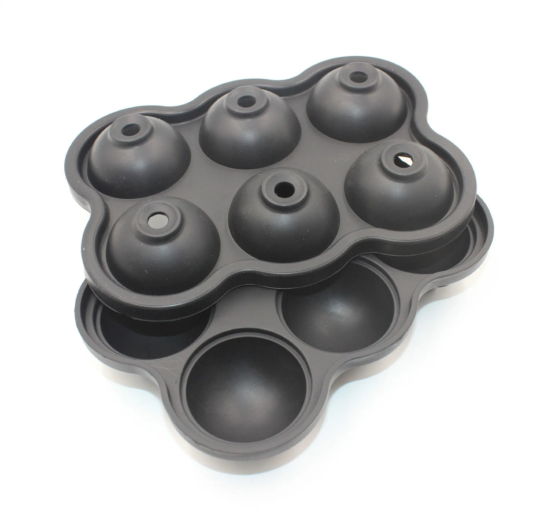 Large black silicone ice cube maker with six 4.5cm sphere cavities on a white background