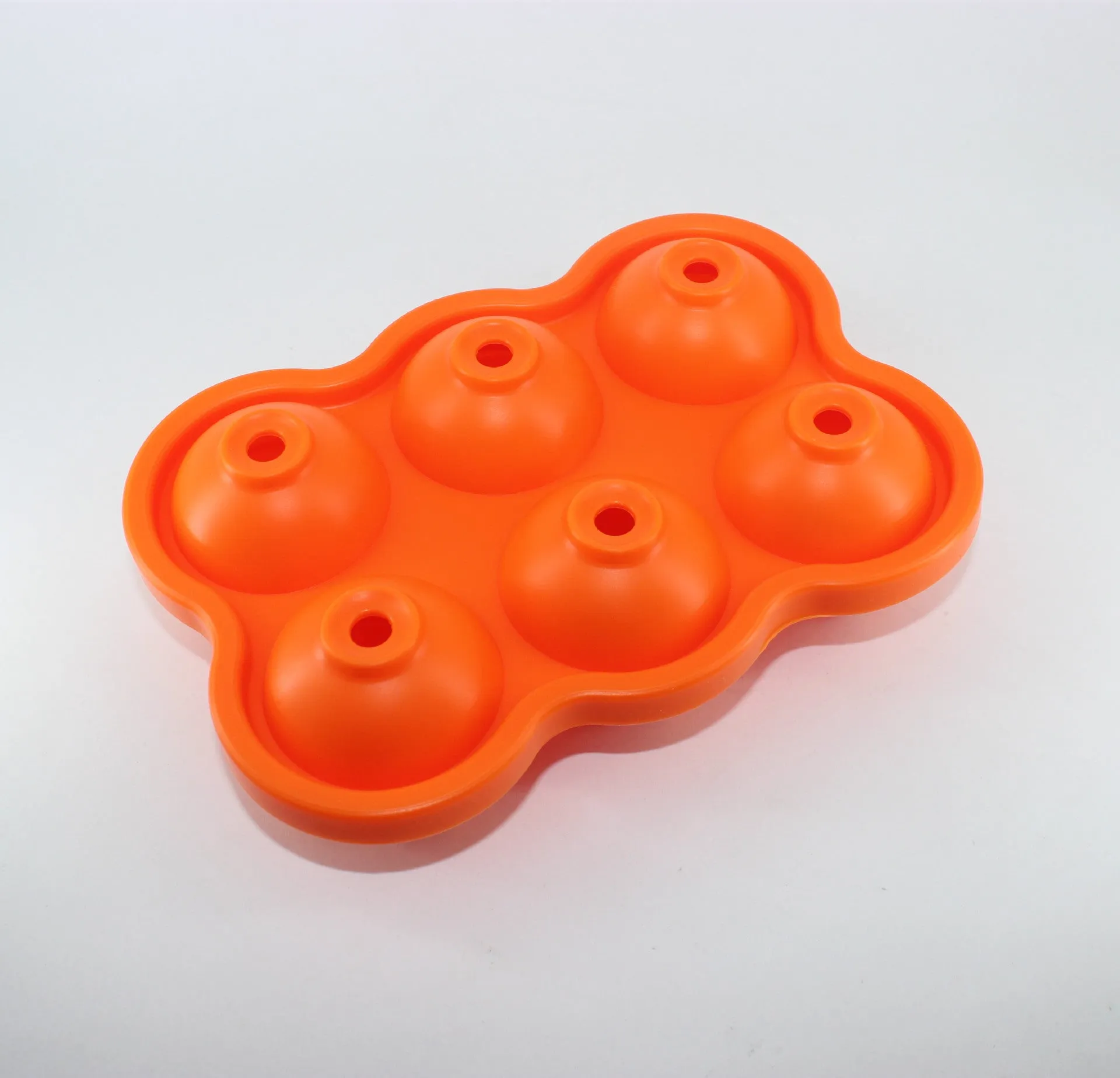 Large black silicone ice cube maker with six 4.5cm sphere cavities on a white background