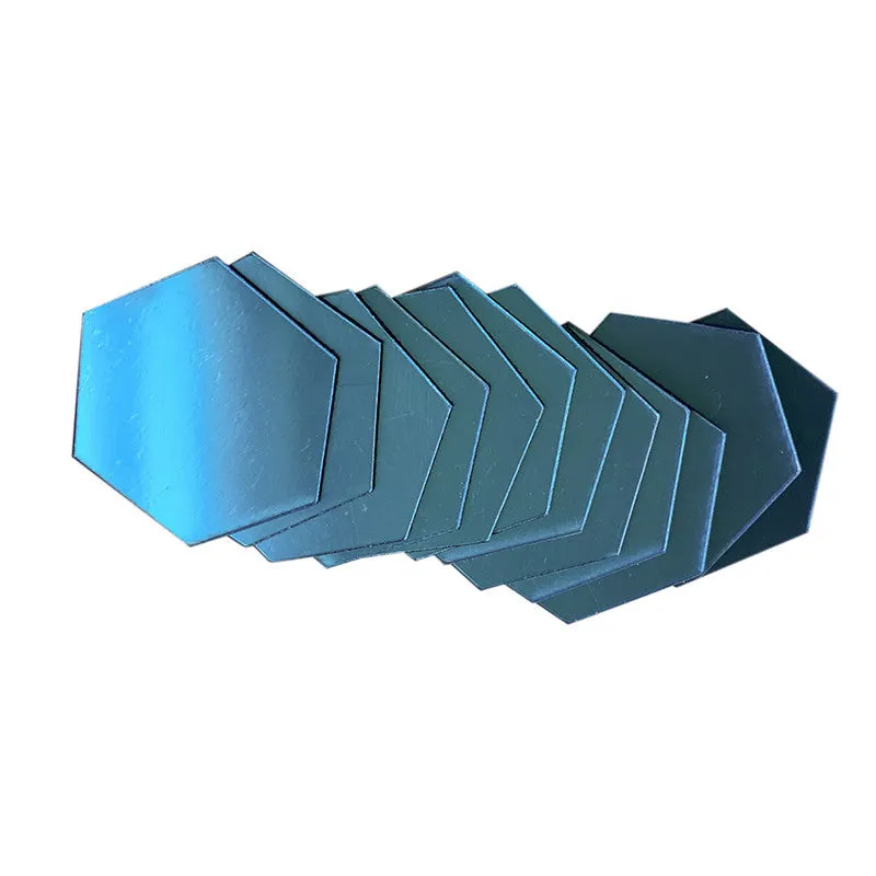 Hexagonal silver PS mirror wall sticker on a wall surface close up