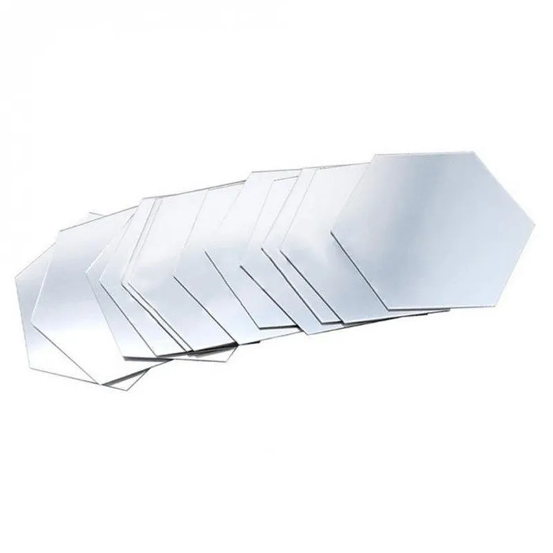 Hexagonal silver PS mirror wall sticker on a wall surface close up