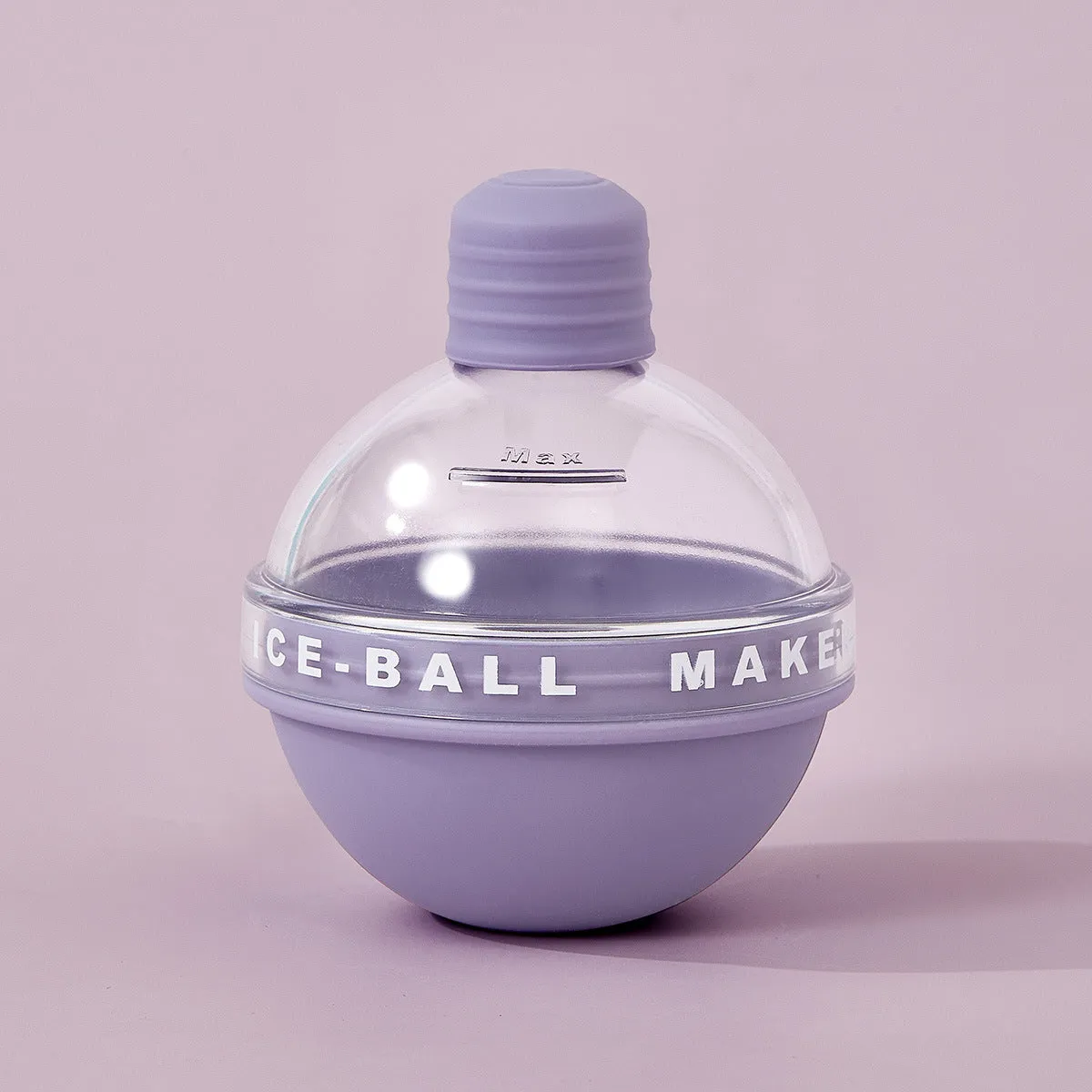 Blue spherical silicone ice ball mold producing a 6cm clear ice ball for whiskey, on a wooden table