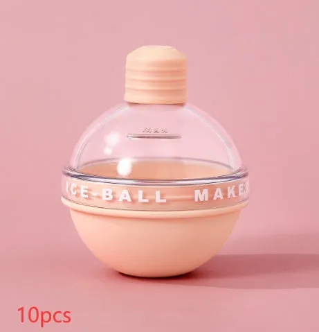 Blue spherical silicone ice ball mold producing a 6cm clear ice ball for whiskey, on a wooden table