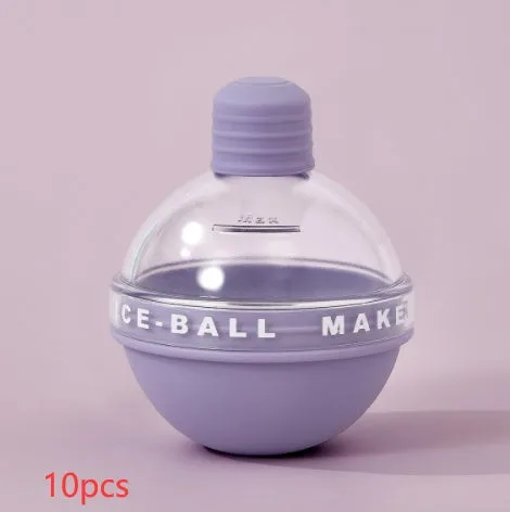 Blue spherical silicone ice ball mold producing a 6cm clear ice ball for whiskey, on a wooden table