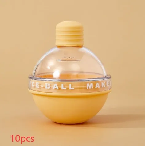 Blue spherical silicone ice ball mold producing a 6cm clear ice ball for whiskey, on a wooden table
