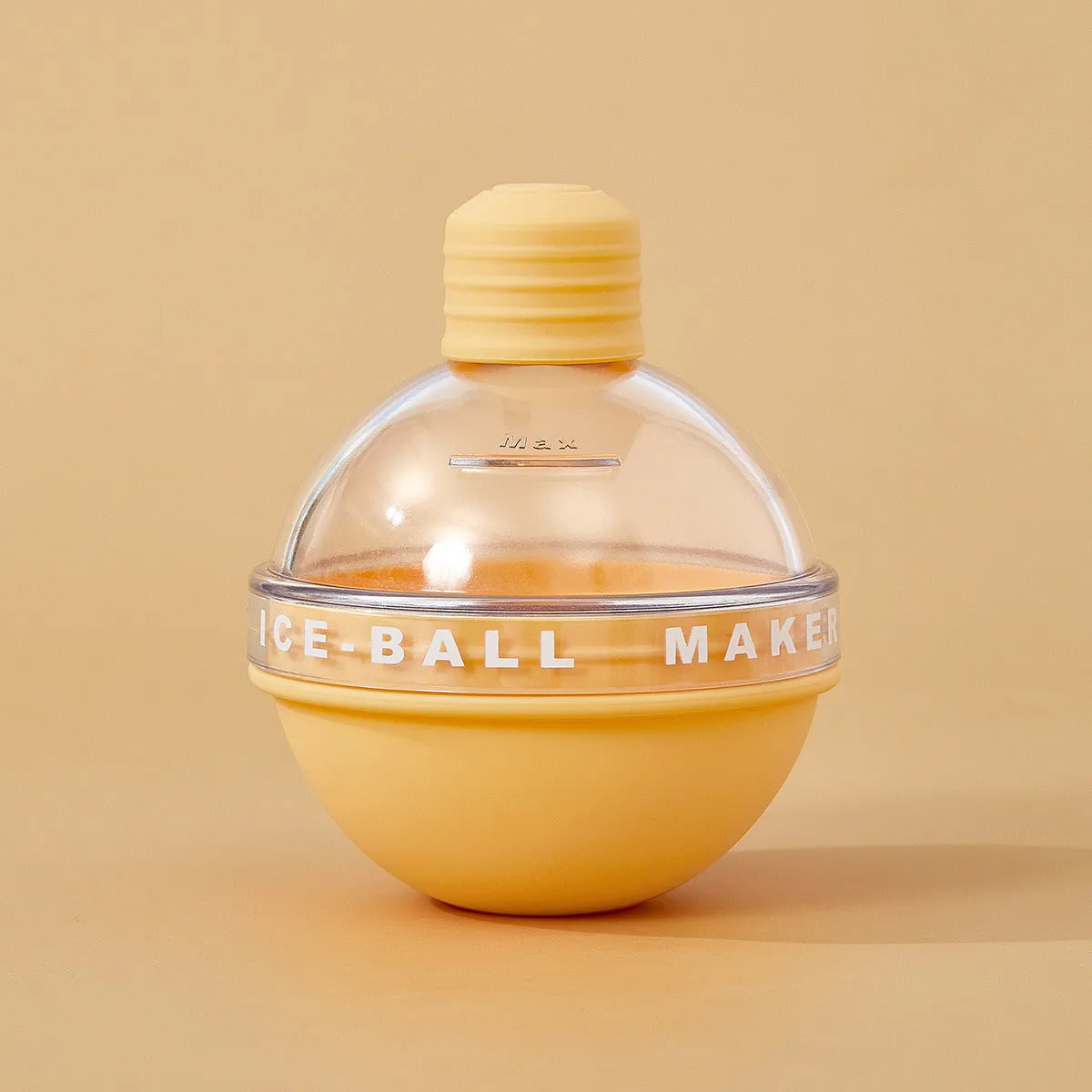 Blue spherical silicone ice ball mold producing a 6cm clear ice ball for whiskey, on a wooden table