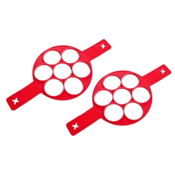 Red silicone egg mould set with heart, lace, round, square and 7-hole shapes on a white background