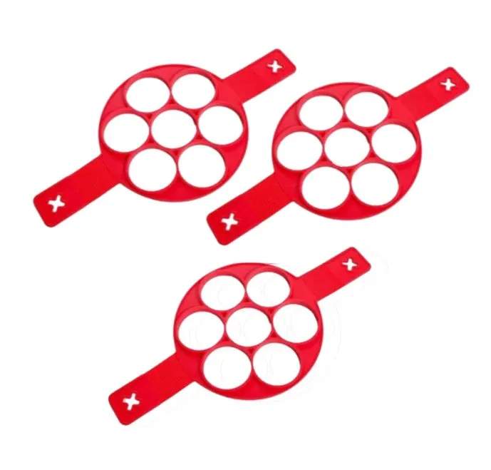Red silicone egg mould set with heart, lace, round, square and 7-hole shapes on a white background