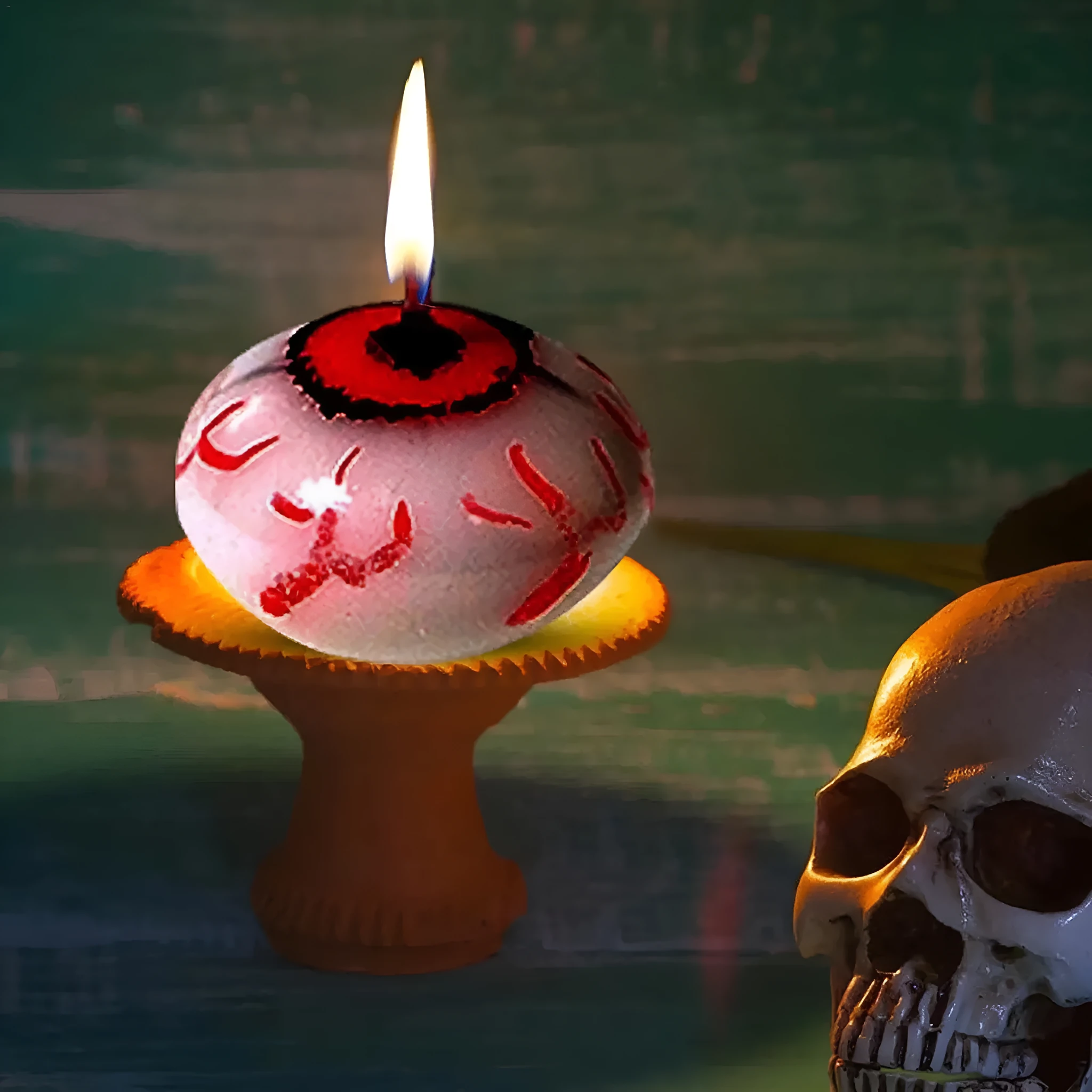 Red oval eyeball floating Halloween candle made from paraffin wax