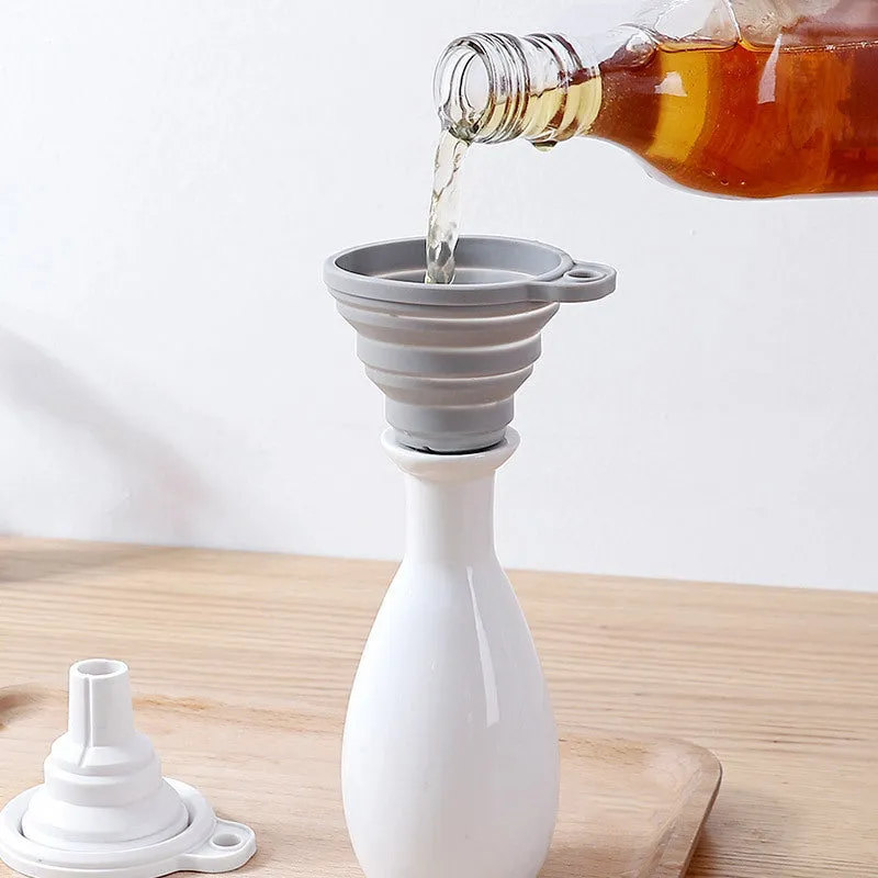 Creative silicone folding funnel in grey and white, collapsed flat on a kitchen surface