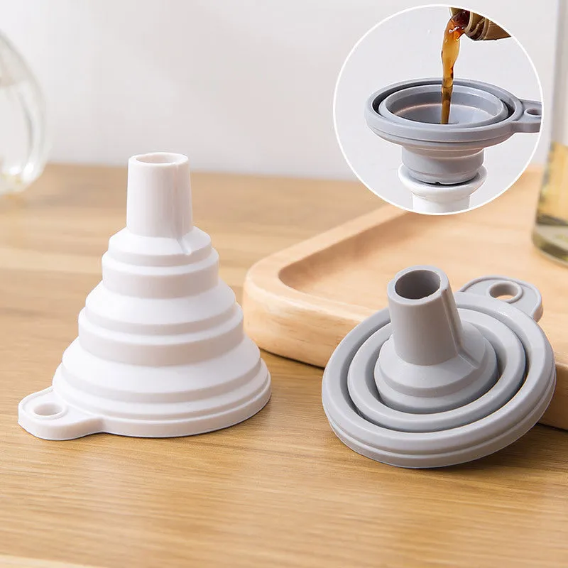 Creative silicone folding funnel in grey and white, collapsed flat on a kitchen surface