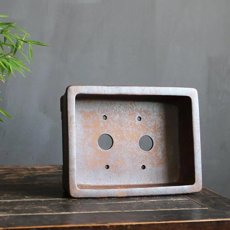 Rectangular purple sand bonsai pot on floor, showing simple five-line basin design.