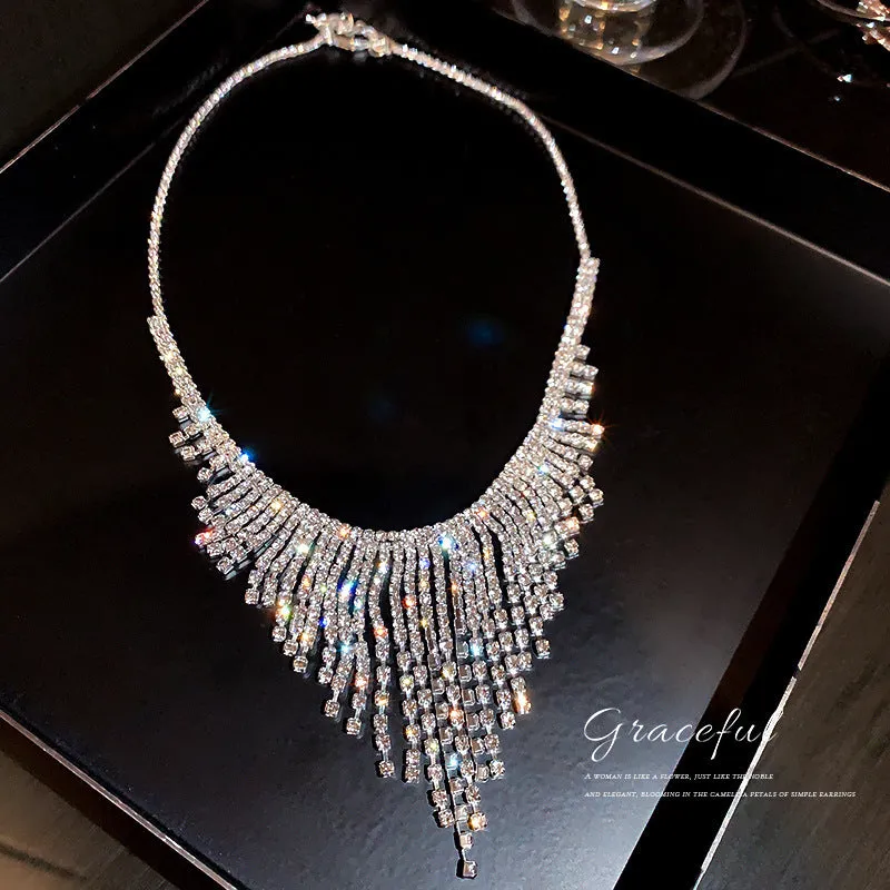 Silver alloy diamond tassel necklace with geometric pendant and ball bead chain on a white background