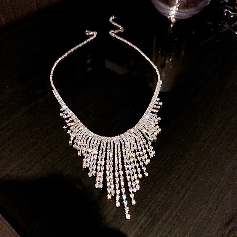 Silver alloy diamond tassel necklace with geometric pendant and ball bead chain on a white background
