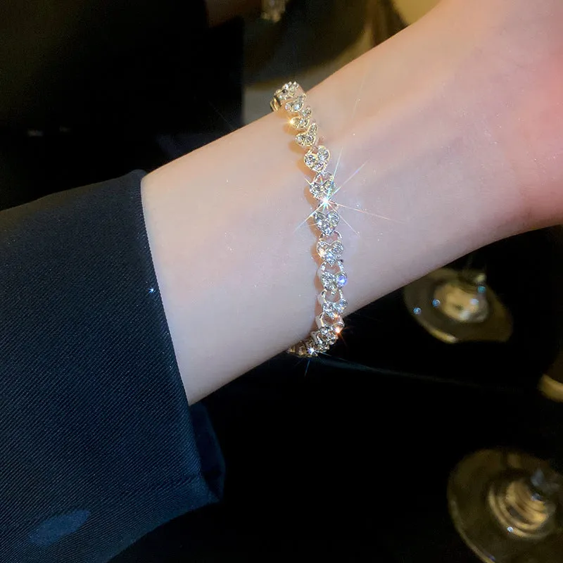 Silver metal bracelet with heart shape and inlaid zircon stones for women