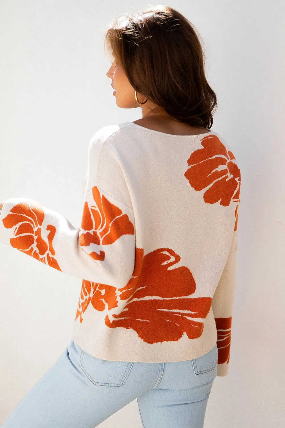 Beige bold flower pattern wide sleeve baggy sweater on display showing loose fit and floral print