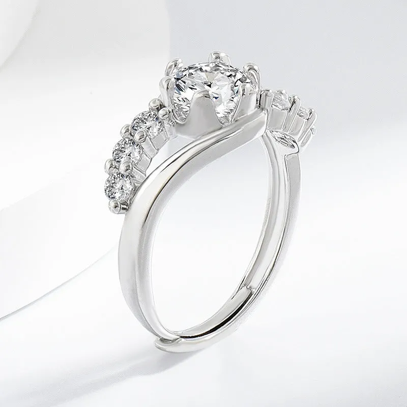White gold colour crown-shaped copper ring on a plain background