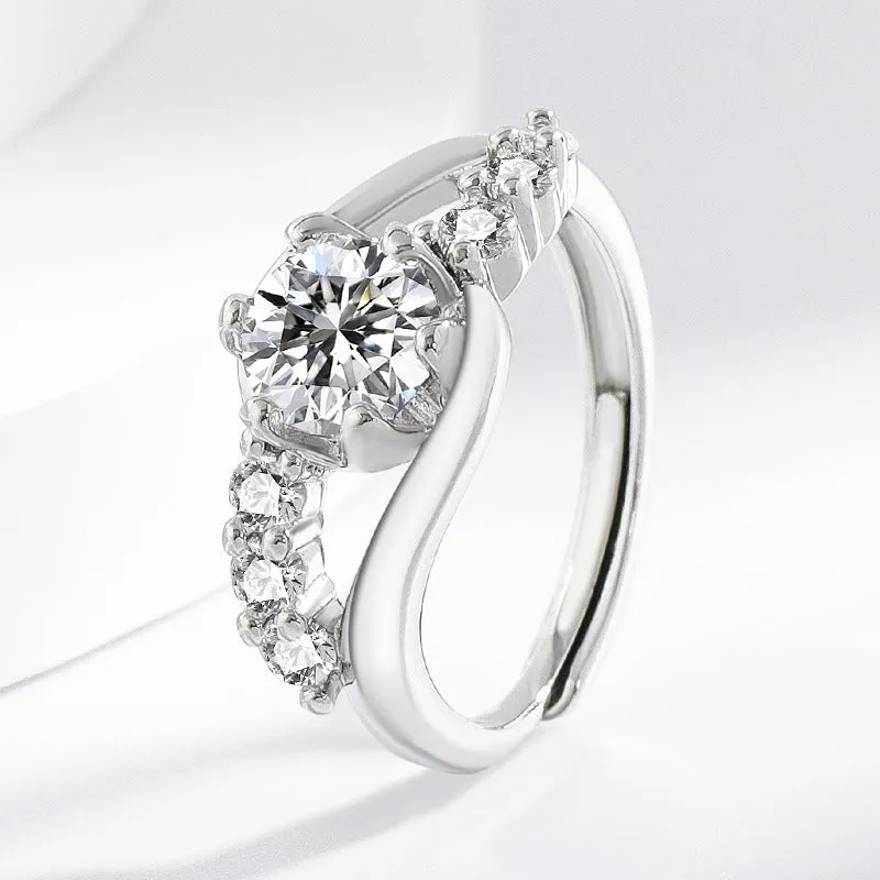 White gold colour crown-shaped copper ring on a plain background