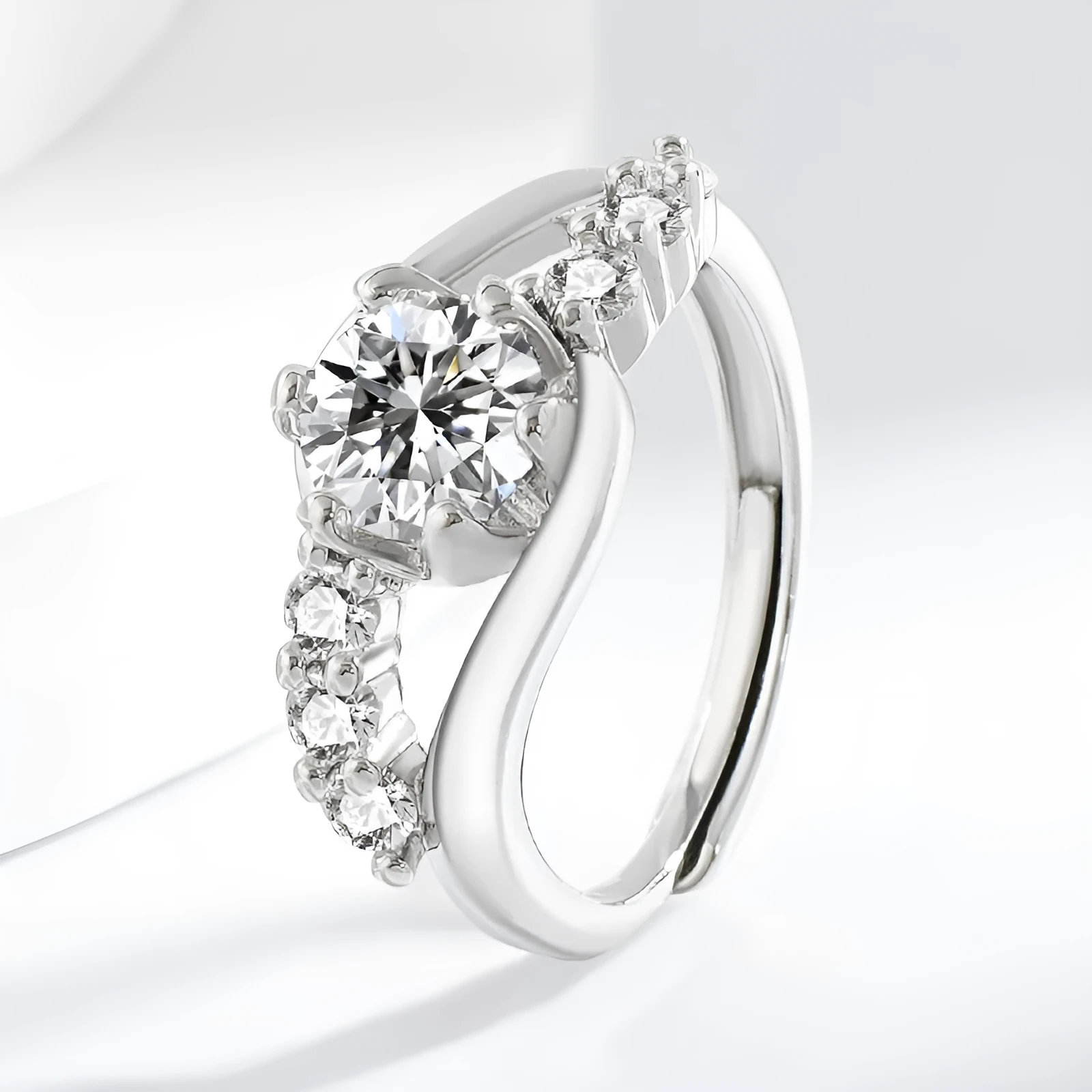 White gold colour crown-shaped copper ring on a plain background