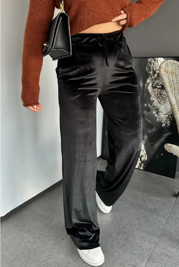 Black shiny velvet high waist drawstring straight leg casual pants on model showing full length