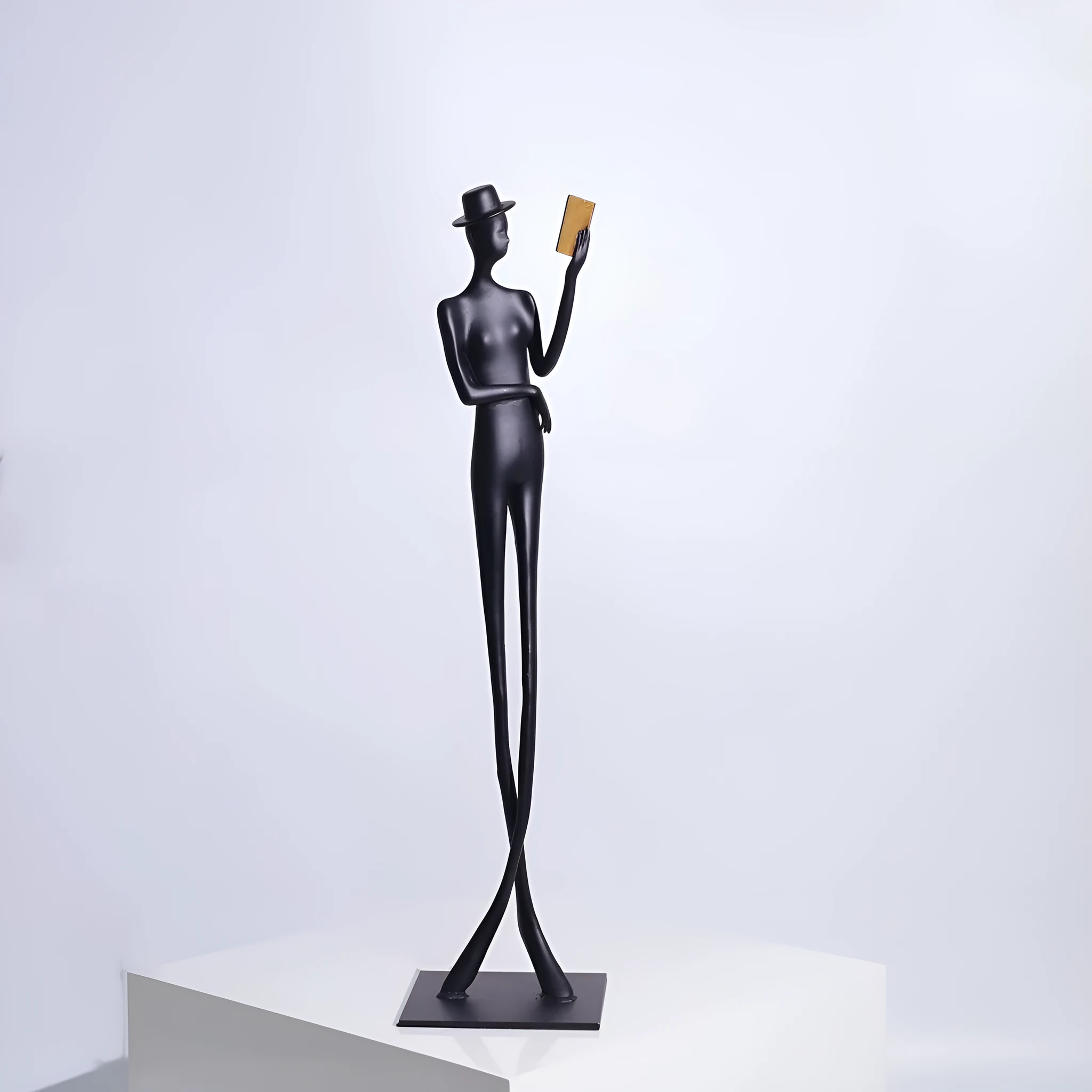 Black cast aluminium desktop sculpture of reading woman measuring 51 cm tall