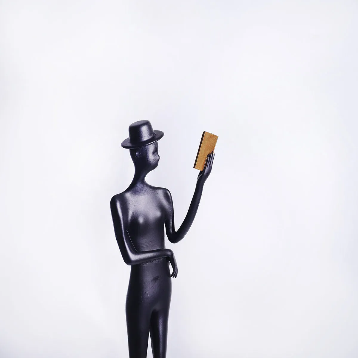Black cast aluminium desktop sculpture of reading woman measuring 51 cm tall