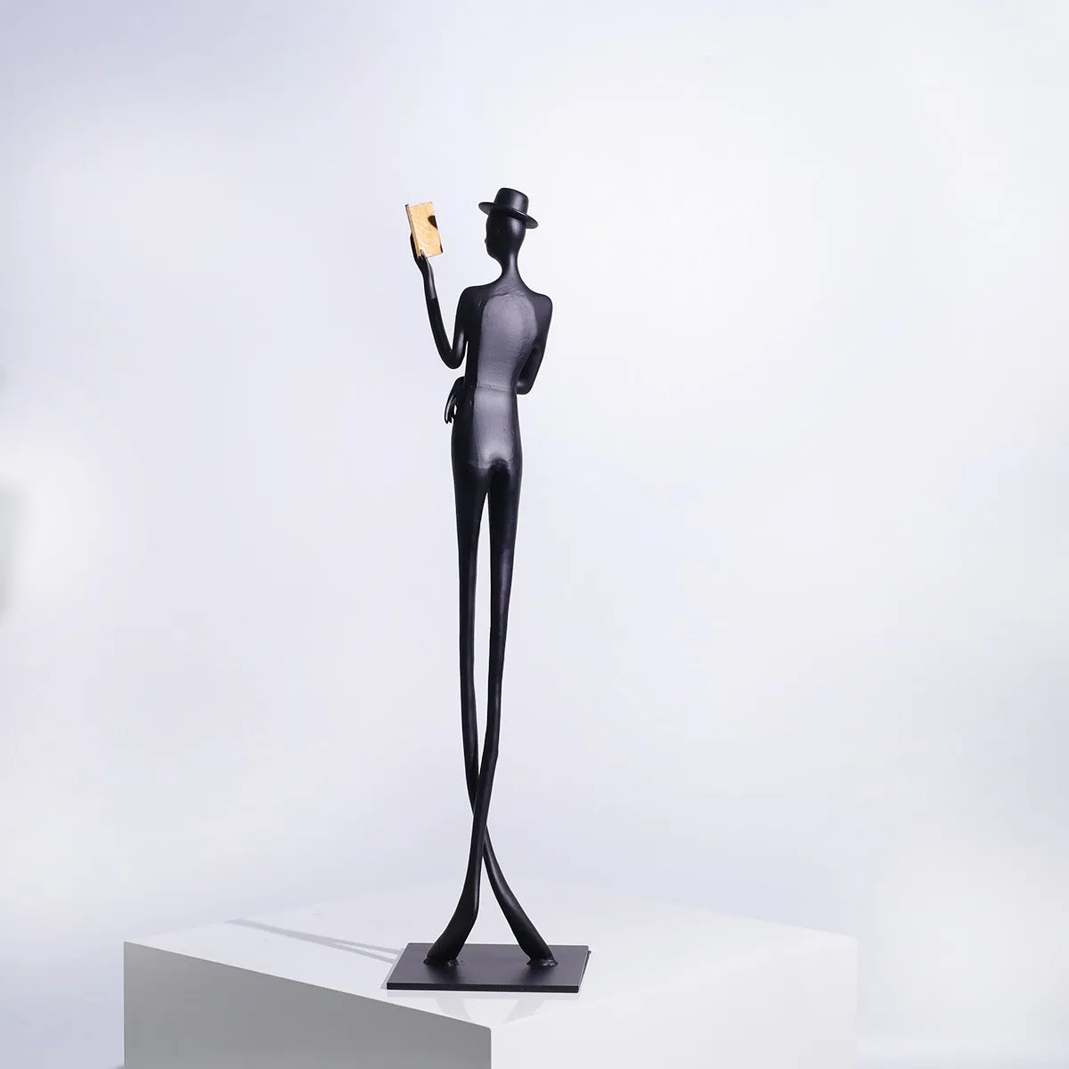 Black cast aluminium desktop sculpture of reading woman measuring 51 cm tall