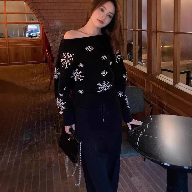 Women's red snowflake jacquard boat neck pullover sweater with long sleeves and crocheted flower details on a white background