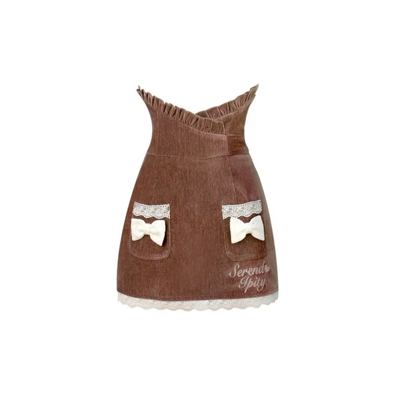 Three-piece apricot knitted top, brown hip skirt, and apricot shawl co-ord set on display