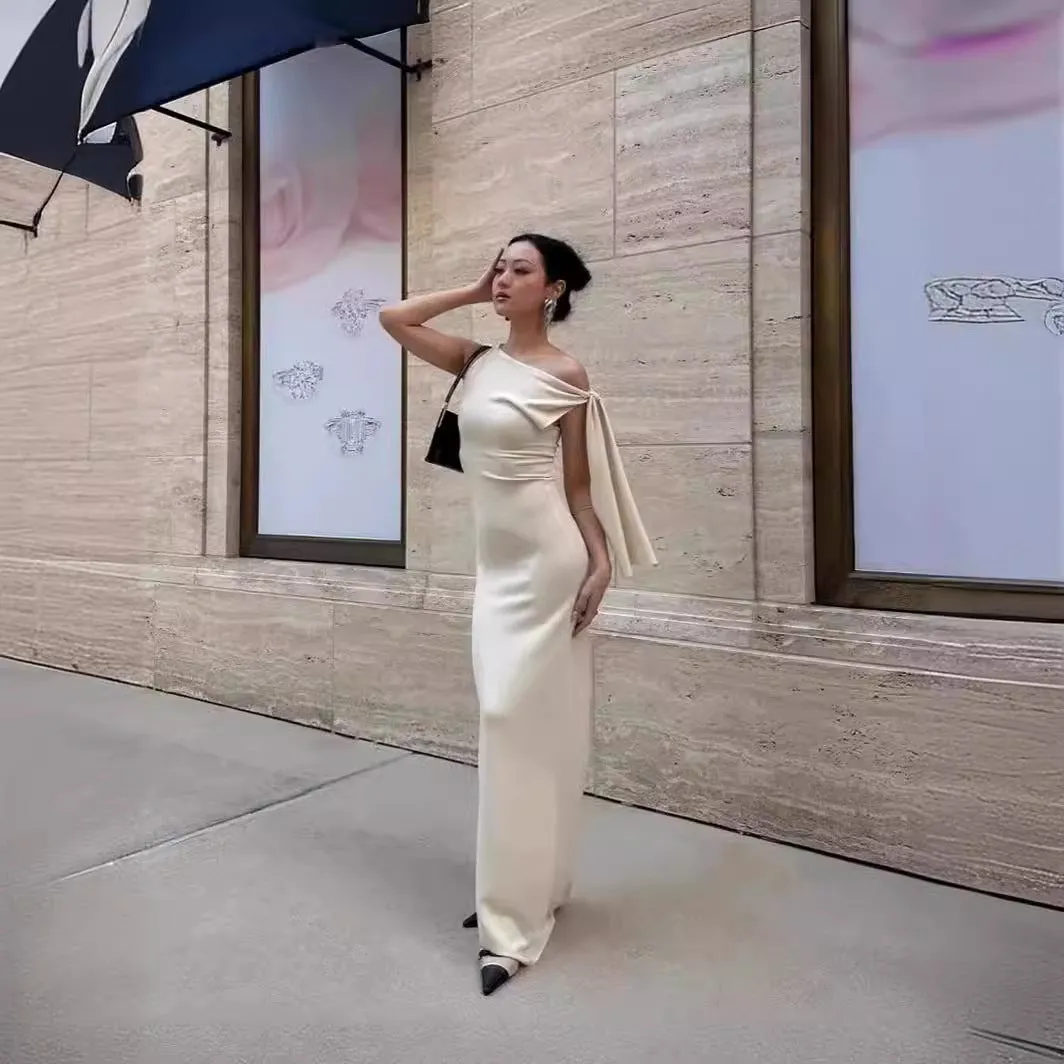 Sloping shoulder women's white long dress with high waist and hip skirt shape, sleeveless design, fold detail