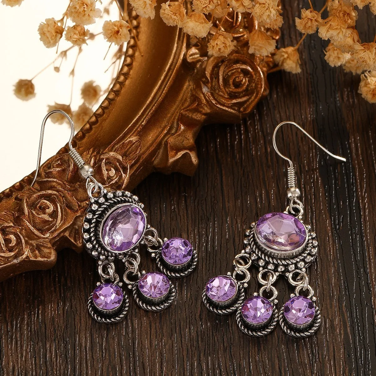 Long tassel alloy earrings in Dark Violet colour with hook fitting, hanging against a light background