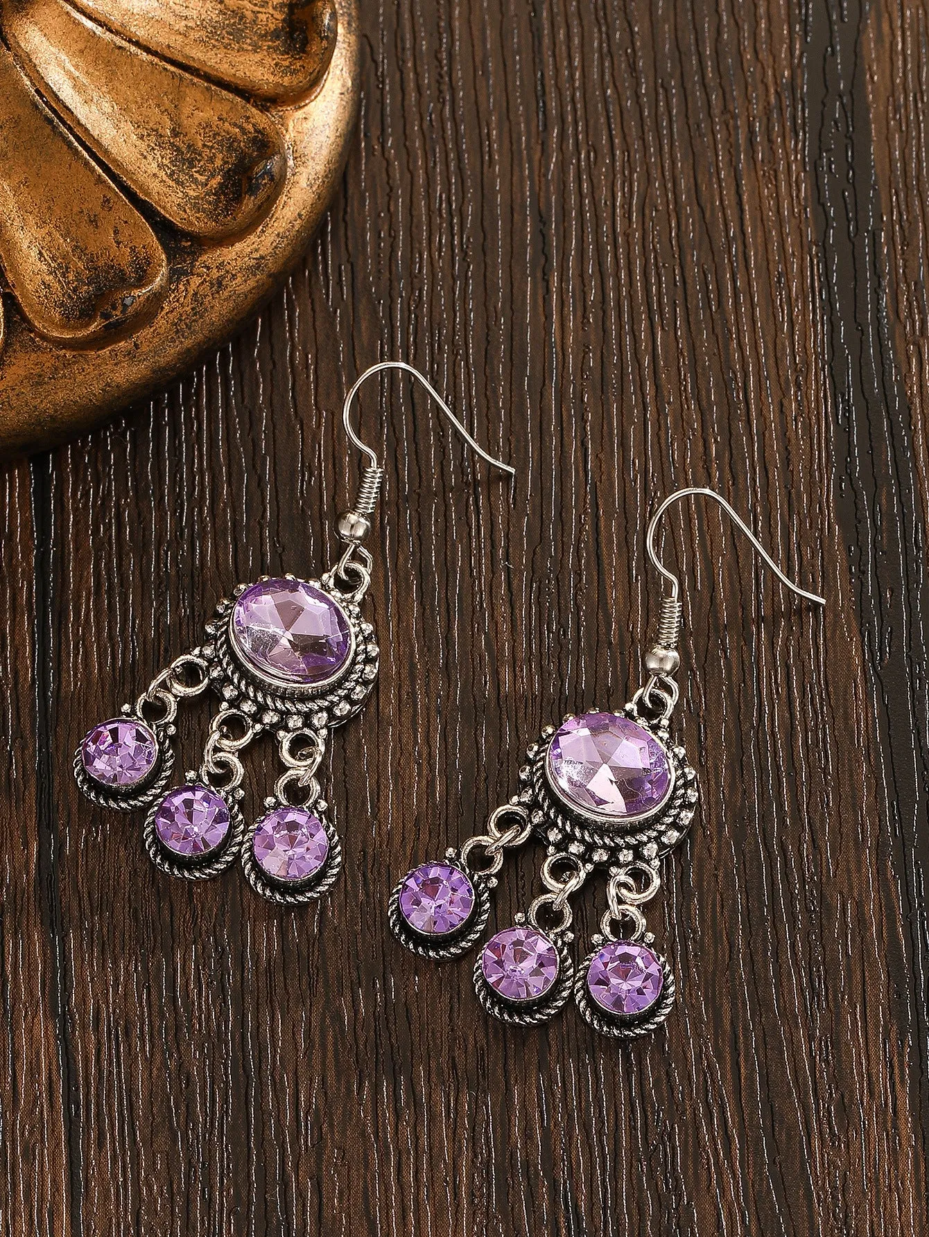 Long tassel alloy earrings in Dark Violet colour with hook fitting, hanging against a light background
