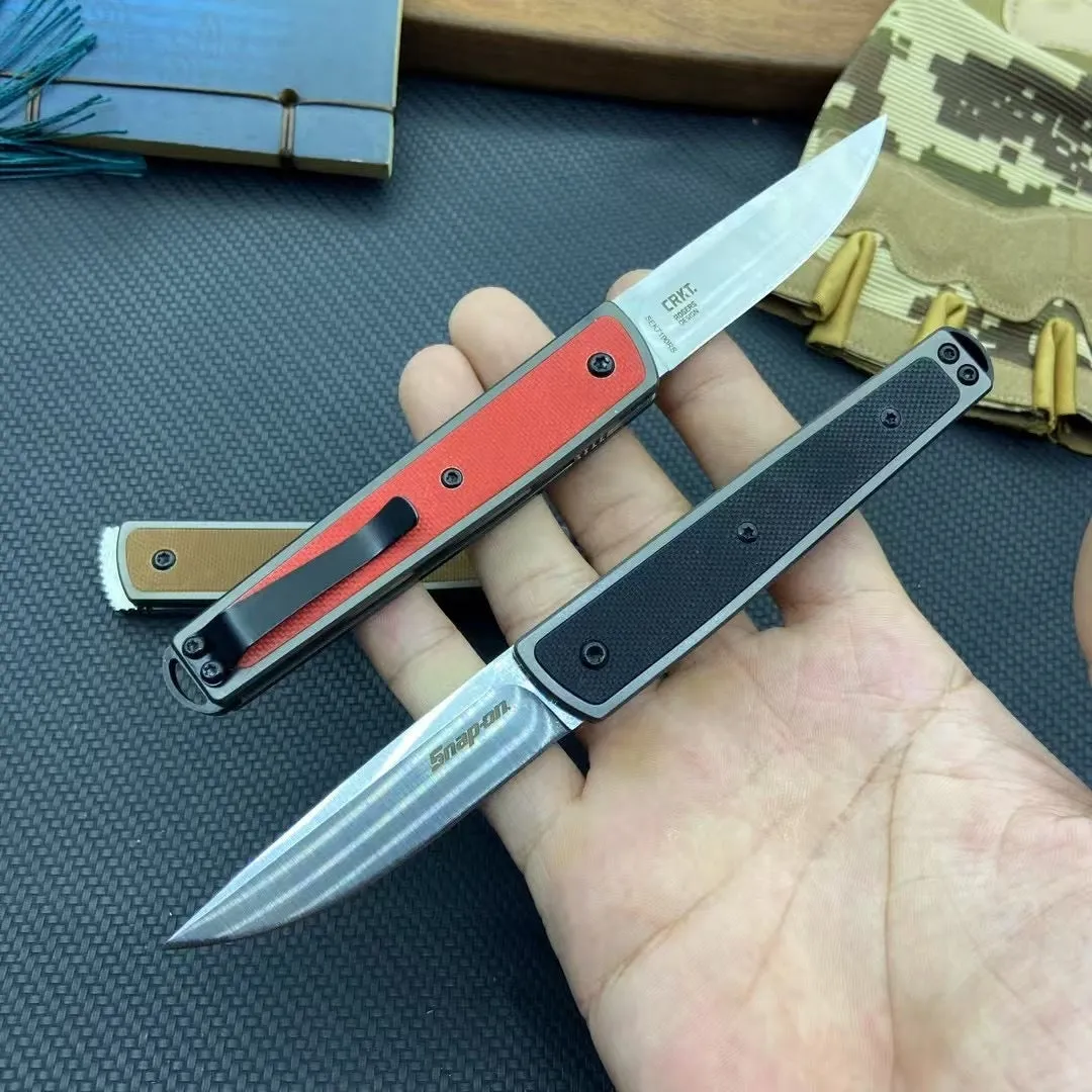Folding fruit knife with stainless steel blade shown in black, brown, and red colour options
