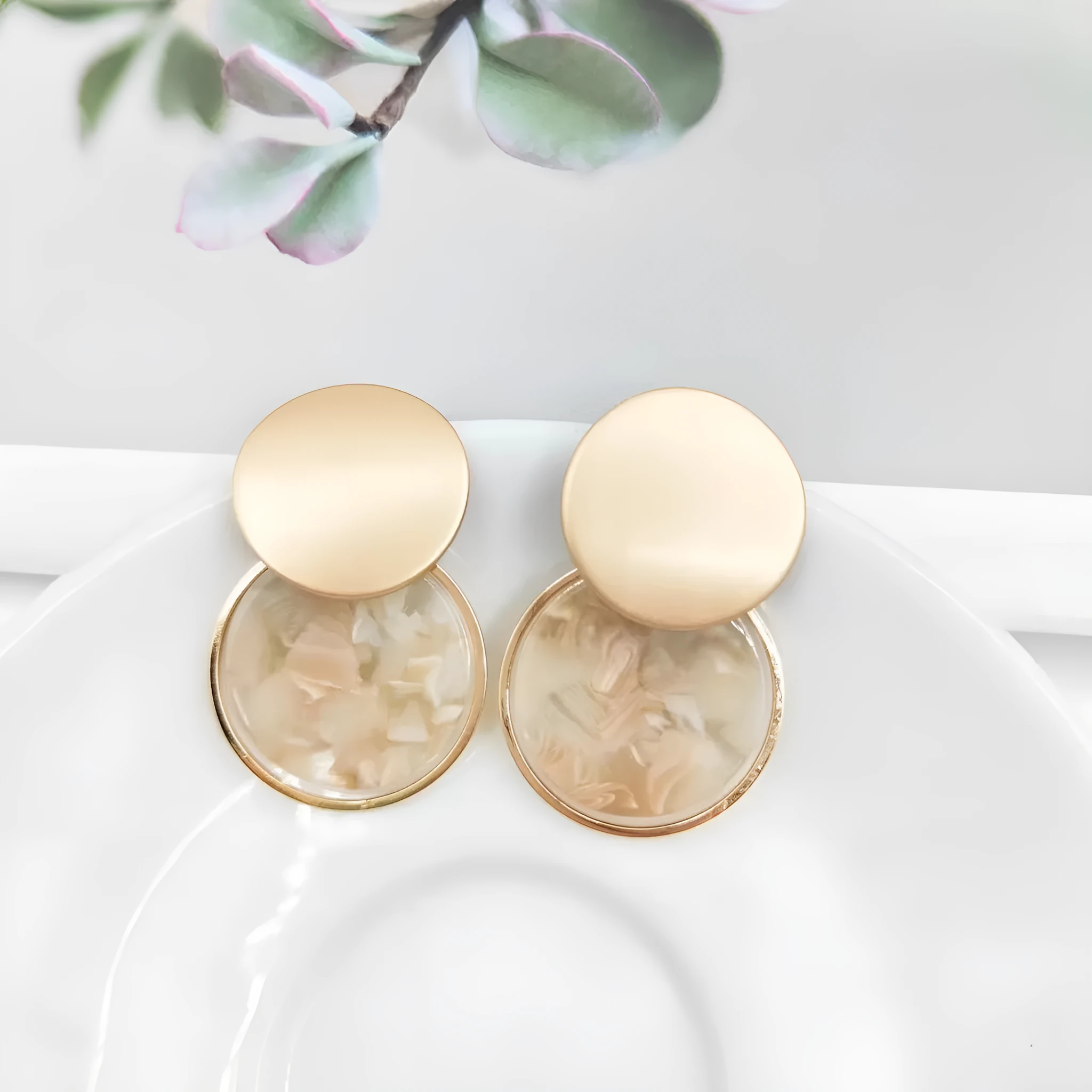 Retro personalized round matte resin female earrings with rotundity shape on a neutral background