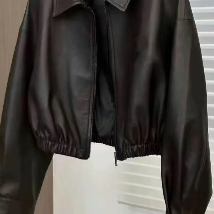 Women's black faux leather square-neck zip jacket with princess sleeves and washed finish on a model