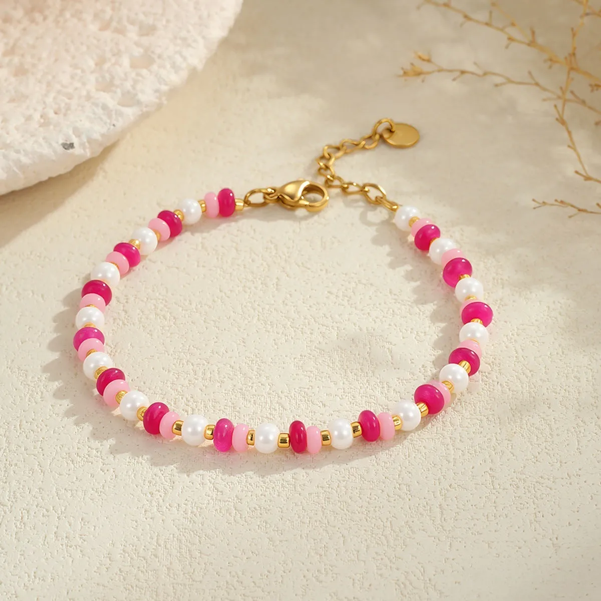 Sweet resin beaded necklace with geometric 18K stainless steel pendant, pink beads, and regular chain on light background