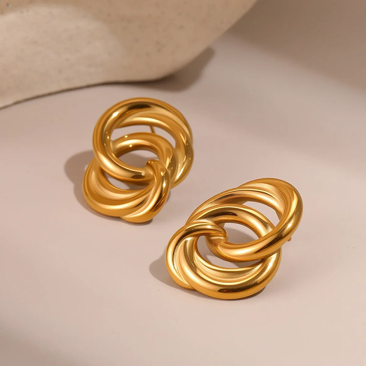 Gold geometric stud earrings with 18K electroplated finish on stainless steel