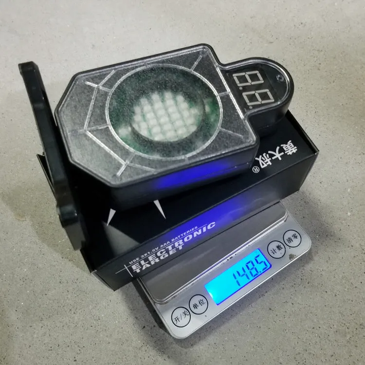 Plastic laser target with light and sound effects, dimensions 9 by 4.7 by 12.8 cm