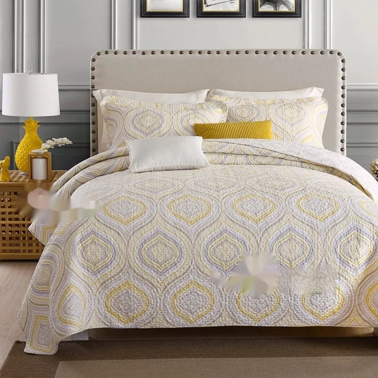 Quilted pure cotton bed cover set with printed pattern on bed, includes two pillowcases.